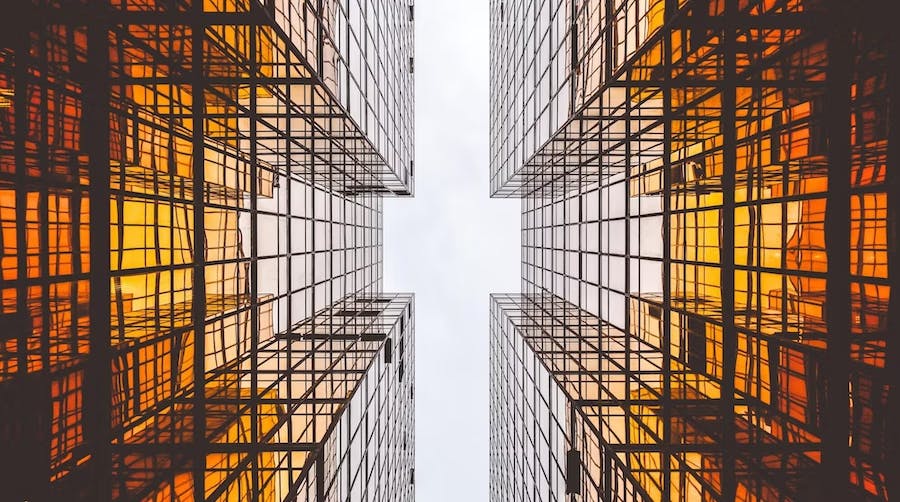 A photo looking up between skyscrappers